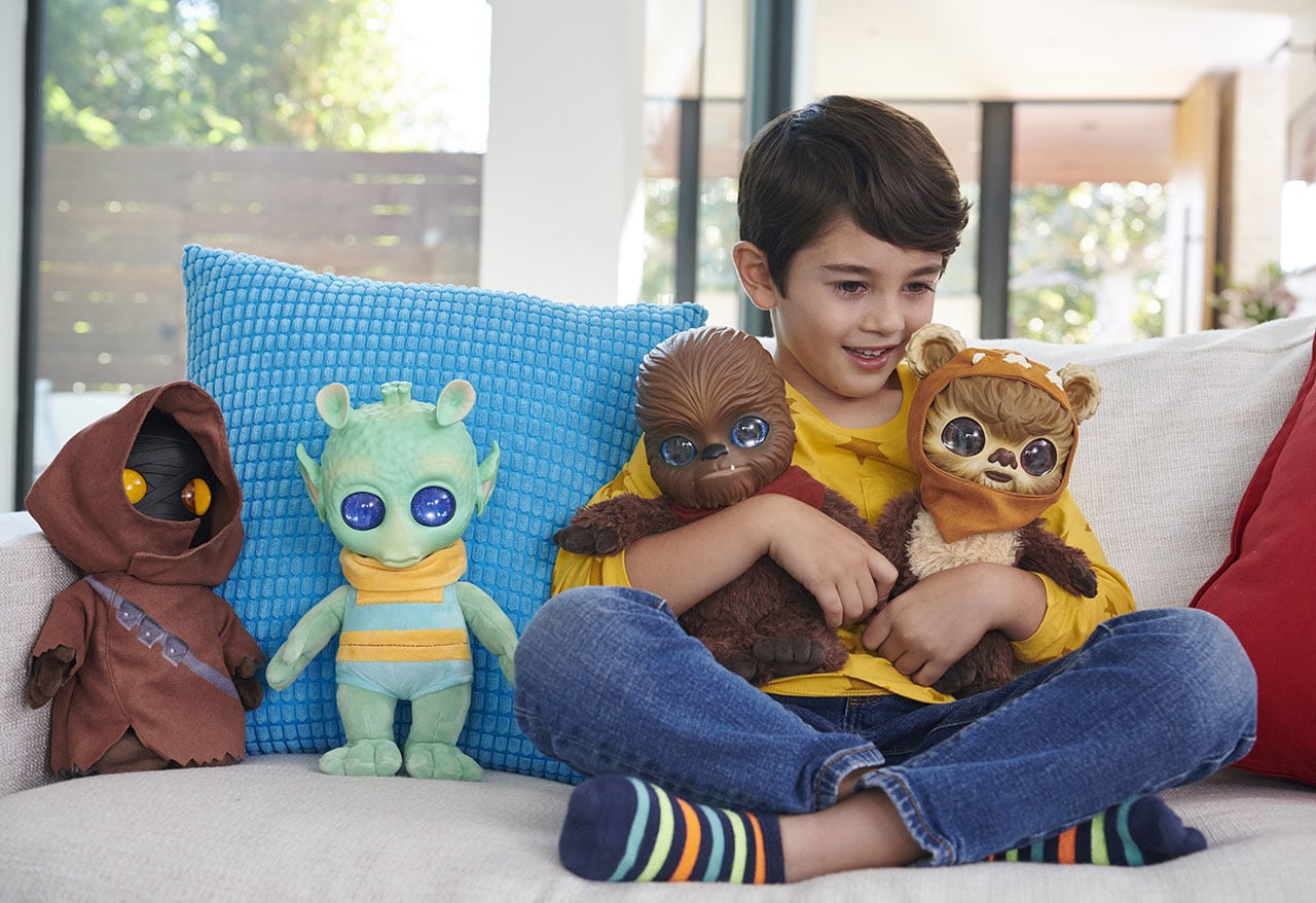 Kid playing with Star Wars Plushes