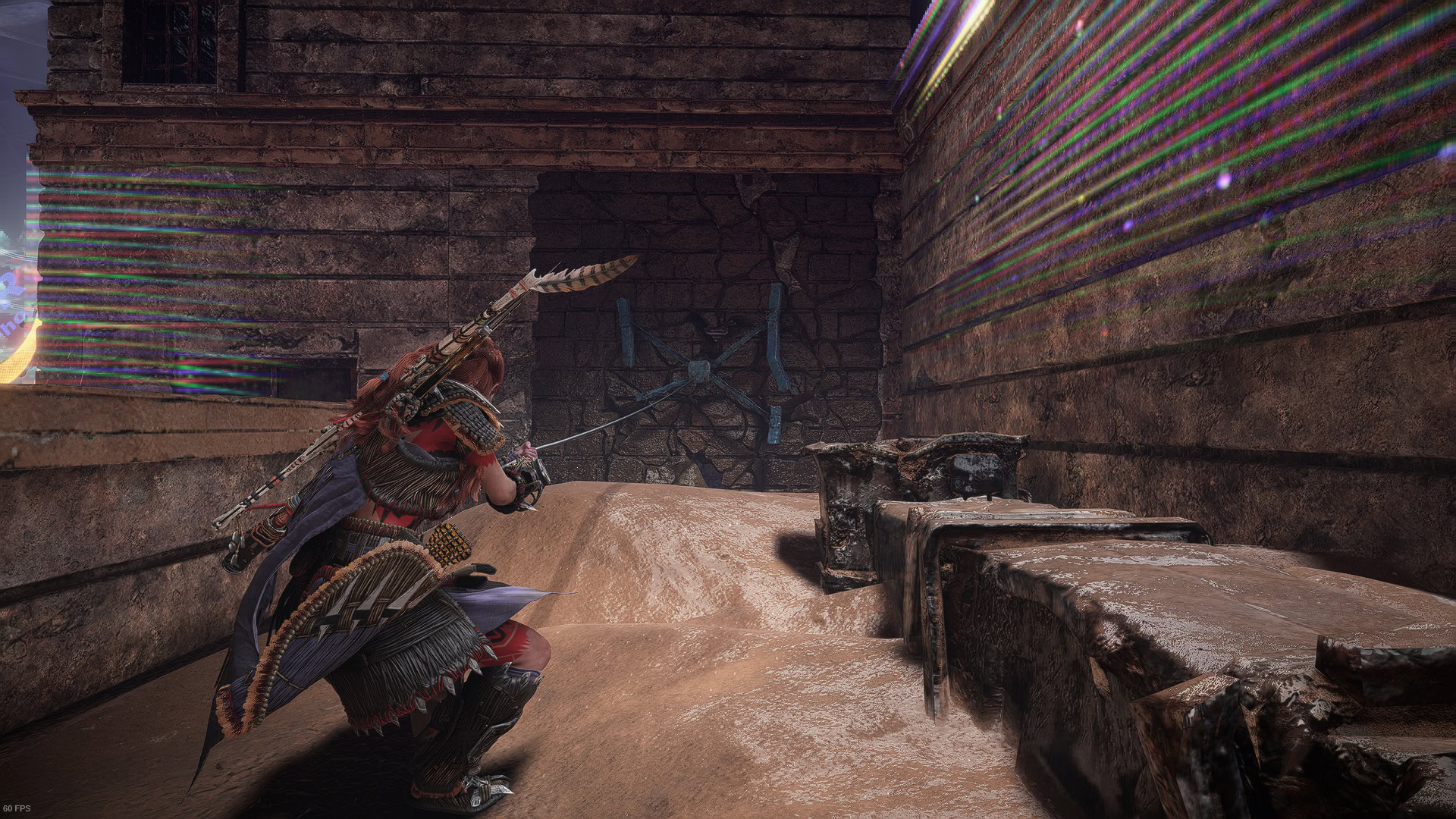 Aloy uses the rope to pull the metal clamp and break the wall
