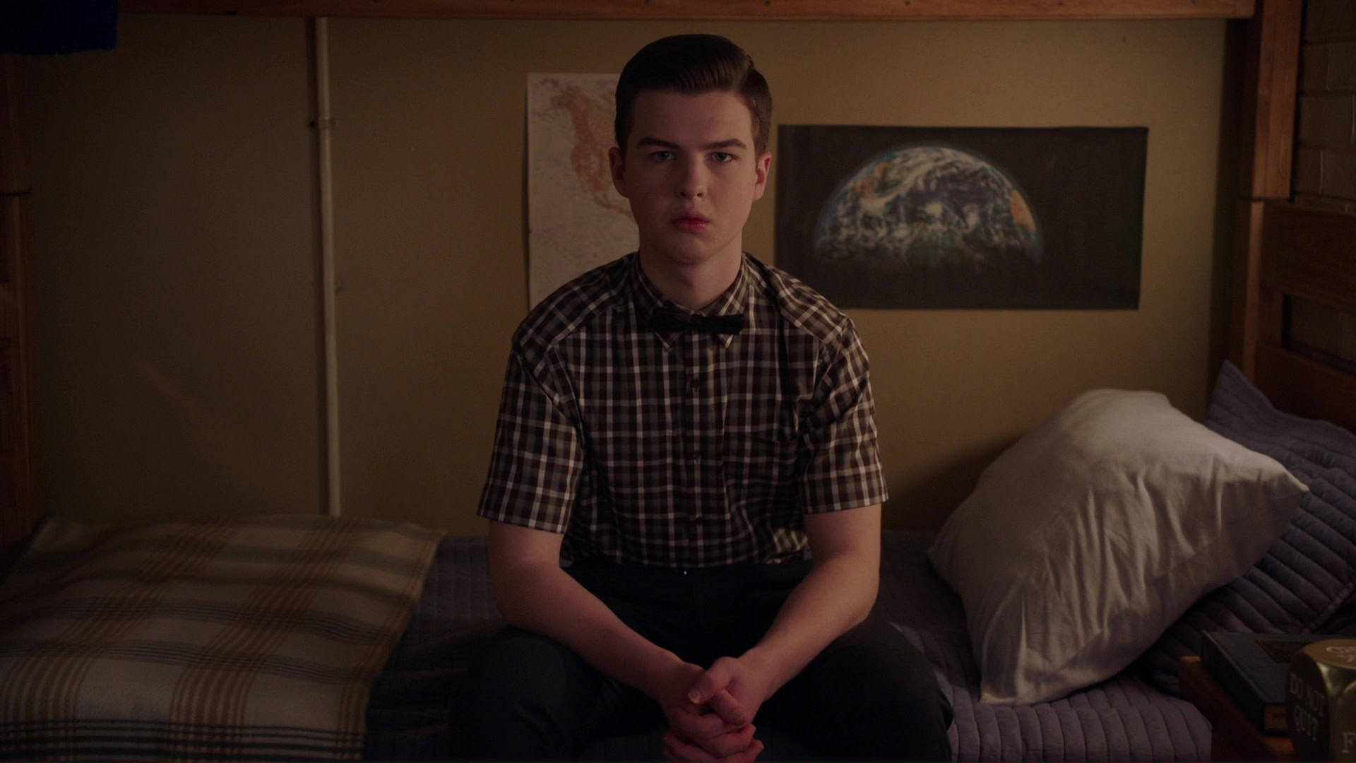 Young Sheldon pondering his father's death, a scene form the show