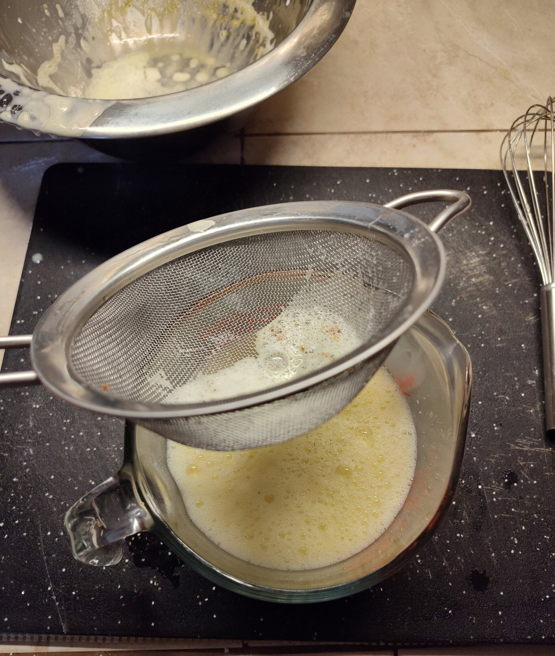 Strain the custard. See how it's foamy at the top after combining?