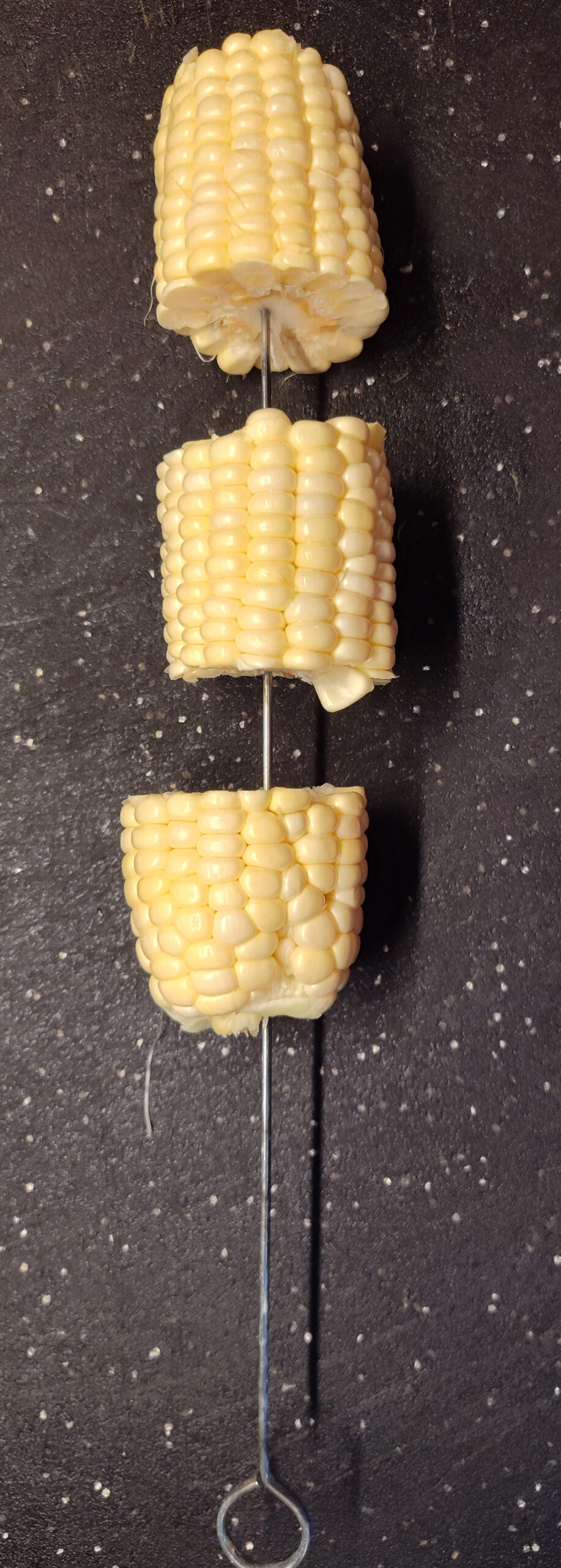 Cut up corn in small pieces and put on a skewer