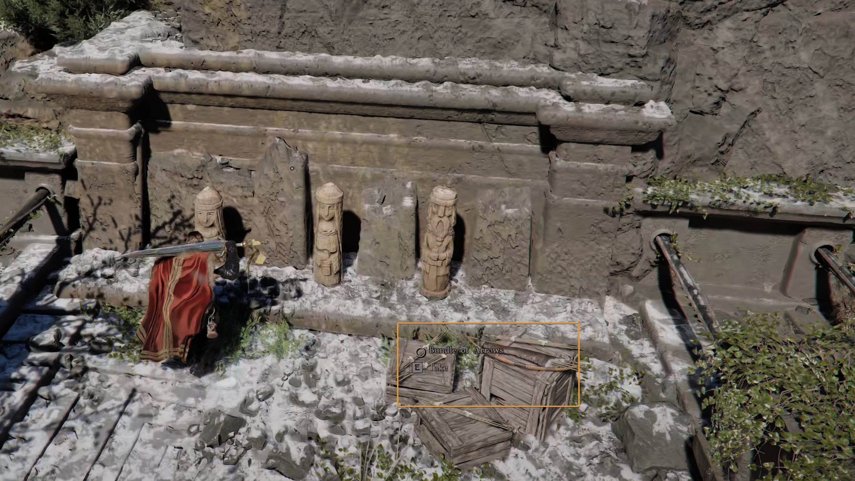 Bundles of arrows and a Bow next to wooden statues