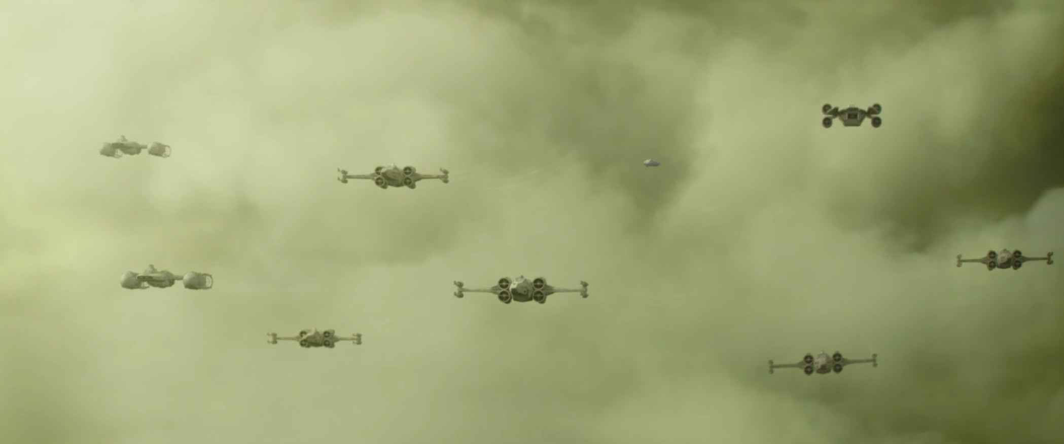 a still show of X-wing and other ships flying in a green sky in the Mandalorian and Grogu final trailer